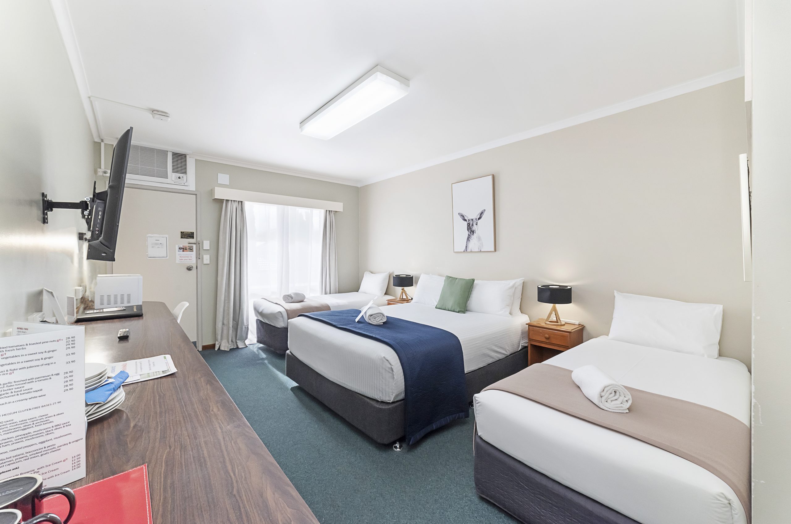 Family room with queen and two single beds at City Heart Motel Warrnambool