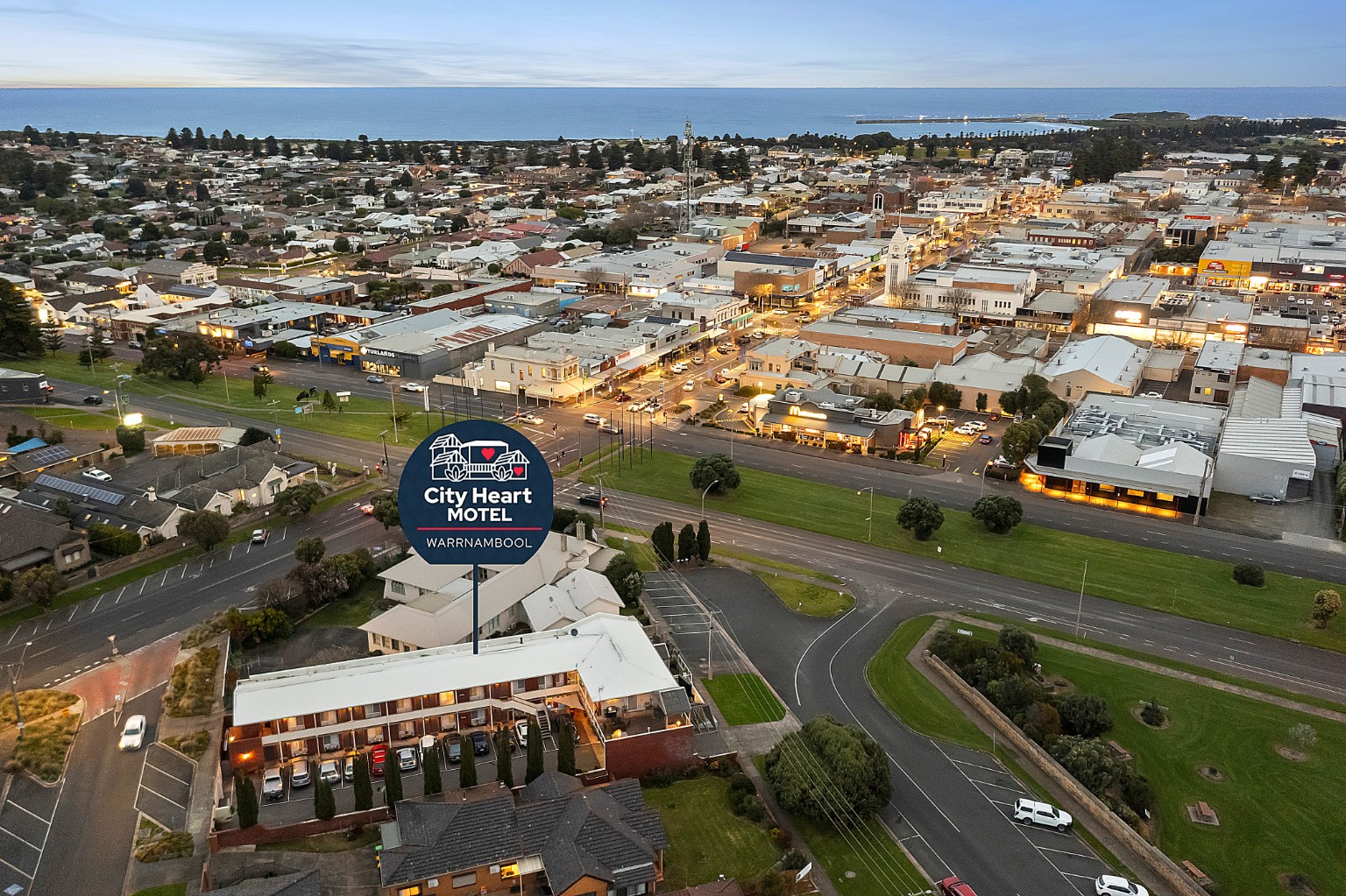 Aerial view of City Heart Motel, Warrnambool CBD and coastline
